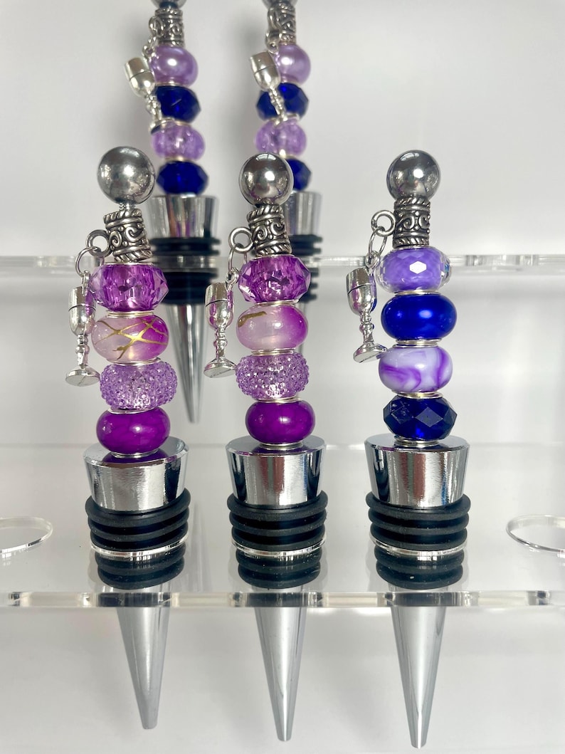 Purple-themed wedding reception supplies - purple beaded wine bottle stoppers
