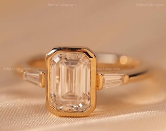 Anillo de compromiso de tres piedras cultivadas en laboratorio con corte esmeralda, solitario de moissanita y anillo de bodas con corte esmeralda y corte baguette cónico lateral.