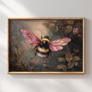 May include: A framed painting of a bumblebee with pink and gold wings. The bee is set against a dark, textured background with foliage and small pink flowers. The frame is gold.