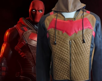 May include: A black, brown, and red hooded jacket with a diamond-quilted front. The jacket features a red bat symbol on the chest and a brown hood. The jacket has a zip closure and red accents on the sleeves.