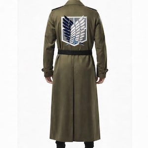 May include: An olive green trench coat with a black belt and a large emblem on the back. The emblem features a white, blue, and grey design. The coat has a long, flowing design and buttoned cuffs.