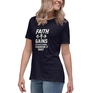 May include: A navy blue t-shirt with the white text "FAITH GAINS", a cross and barbell graphic. The shirt also has the text "MY FAITH IS STRONG... I EXERCISE IT DAILY".