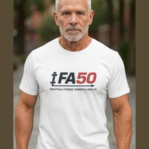May include: White t-shirt featuring the text "iFA50" in black and red, with the tagline "PRACTICAL FITNESS. POWERFUL RESULTS." A black arrow is part of the design. The shirt has short sleeves.