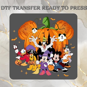 May include: A DTF transfer ready to press featuring a Halloween-themed graphic with Mickey Mouse and friends in costumes. The design includes a large orange pumpkin, spider webs, bats, and ghost icons against a dark gray background.