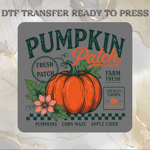 May include: A DTF transfer ready to press featuring a graphic with a large orange pumpkin, green leaves, and a pink flower. The text reads PUMPKIN PATCH, FRESH FROM THE PATCH, FARM FRESH, LOCALLY GROWN, AUTUMN PIKED, PUMPKINS, CORN MAZE, APPLE CIDER.
