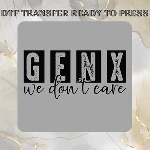 May include: A gray DTF transfer with the text "GENX we don't care" in black. The words "GENX" are in individual black boxes. The phrase is in a handwritten style font.