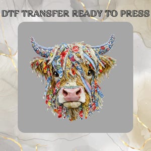 May include: A DTF transfer ready to press featuring a Highland cow illustration. The cow has long, shaggy fur adorned with colourful floral fabric strips in shades of red, blue, yellow, and green. The horns and face are covered in patterned fabric.