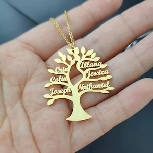 May include: A gold-coloured family tree pendant necklace. The tree design features names: Orin, Colin, Joseph, Allana, Jessica, and Nathaniel. The necklace has a delicate chain.