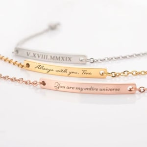 May include: Three delicate bar bracelets in silver, gold, and rose gold. Each bracelet features a chain and a rectangular bar with engraved text. The gold bracelet reads "Always with you, Tina." The rose gold bracelet reads "You are my entire universe."