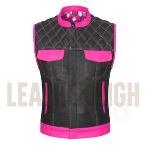 May include: Black leather vest with hot pink accents. The vest features a quilted pattern on the shoulders and upper chest, with two front pockets and a stand-up collar. The interior lining is patterned. The vest has a modern, edgy style.