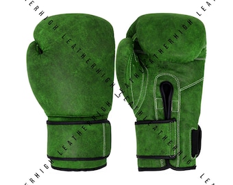 May include: A pair of green boxing gloves. The gloves are made of leather and have a textured surface. The gloves have a black wrist strap and white stitching.