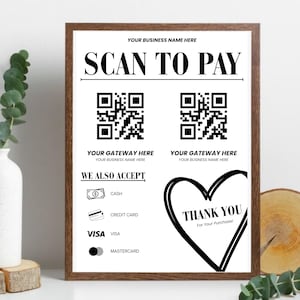 Può includere: Un cartello rettangolare in una cornice di legno scuro con il testo SCAN TO PAY, due segnaposto per codici QR e opzioni di pagamento come contanti, carta di credito, Visa e Mastercard, insieme alle scritte WE ALSO ACCEPT e THANK YOU.