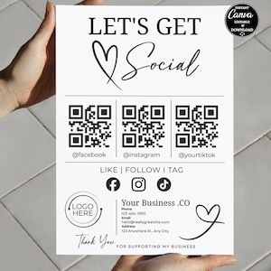 May include: A white sign with black text that reads "LET'S GET Social." It includes QR codes for Facebook, Instagram, and TikTok, along with social media icons. The sign also features a space for a logo and business contact information.
