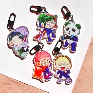 May include: A collection of six acrylic keychains featuring anime-style characters. Each keychain has a black clasp and depicts a different character in vibrant colors. The characters have unique hairstyles and outfits, with various facial expressions.