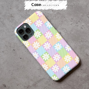 May include: A pastel phone case with a daisy and checkerboard pattern. The case has a repeating design of white daisies on a grid of pastel squares and stripes. The text "Case Collection" is at the top.