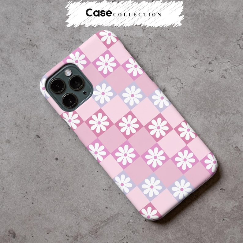 May include: A pink phone case featuring a checkerboard pattern of daisies. The design incorporates squares of light and dark pink, and lavender, with white daisies. The text "Case Collection" is at the top of the image.