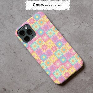 May include: A pastel-coloured phone case with a daisy pattern. The case displays a grid of squares, each with a daisy in pink, yellow, blue, and purple. The text "Case Collection" is at the top of the image.