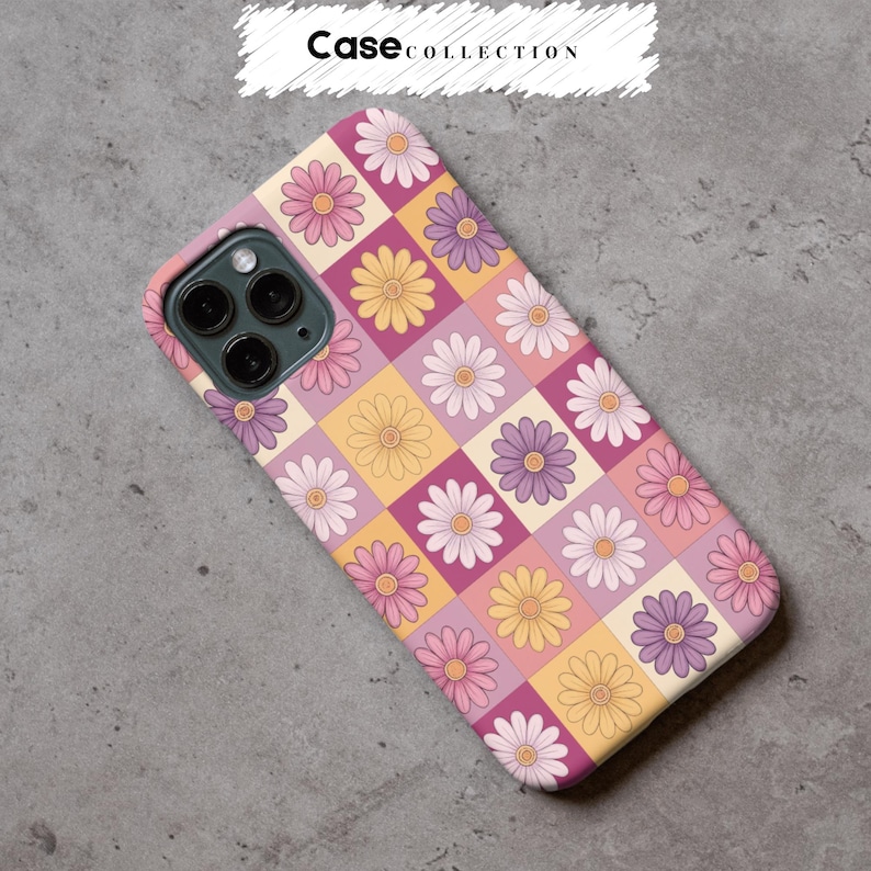 May include: A phone case featuring a daisy pattern in pink, purple, and yellow squares. The case has a floral design and the text "Case Collection" in a white banner.