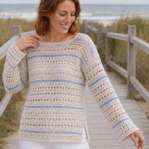 May include: A long-sleeved crochet jumper featuring a cream-coloured base with horizontal light blue stripes. The garment has a wide boat neckline, an open-work stitch pattern throughout, and small side slits at the bottom hemline.