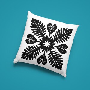 May include: White square pillow with a black floral design. The design features a central starburst surrounded by stylized leaves and heart-shaped leaves. The pillow is set against a teal background.