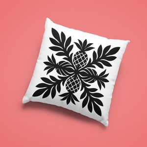 May include: Square white pillow with a black pineapple and leaf design. The design features four pineapples surrounded by leaves, creating a symmetrical pattern. The pillow is on a coral-colored background.