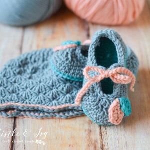 May include: A set of crocheted baby booties and a hat in gray, pink, and teal. The booties have a bow and a flower detail. The hat has a pink trim.