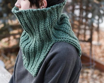 May include: A green crocheted cowl neck warmer. The cowl is made with a ribbed stitch and is folded over at the top.