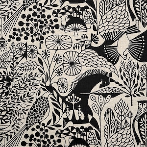 May include: Black and off-white fabric with a repeating pattern of stylized birds, plants, and other natural elements. The design features intricate details and a high contrast between the black shapes and the neutral background. The overall theme is nature and botanical.