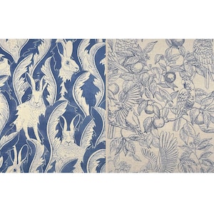 May include: Two fabric panels with repeating patterns. One features white rabbits and foliage on a blue background. The other displays a detailed illustration of birds, fruit, and branches in blue on a beige background.