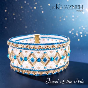 May include: A wide cuff bracelet crafted from white, metallic gold, and bright turquoise seed beads. The design features a repeating geometric diamond pattern with horizontal borders of gold and turquoise beads. The text Al Khazneh Designs and Jewel of the Nile are visible.