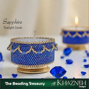May include: A beaded tealight cover in sapphire blue with gold accents. The cover has a detailed pattern and is adorned with small beads. The text "Sapphire Tealight Cover" is visible. The base is gold, and the overall design is elegant.