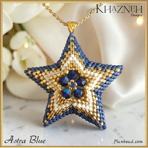 May include: A star-shaped pendant crafted from blue, white, and gold beads, featuring a central flower motif made of five dark blue faceted crystals. The pendant hangs from a thin gold chain. The text "KHAZNEH Designs" and "Astra Blue" are visible.