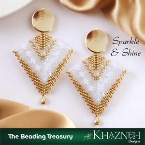 Könnte beinhalten: Ein Paar gold-weiß Perlenohrringe. Die Ohrringe haben ein geometrisches Design mit einer goldenen Scheibe oben und einem tropfenförmigen Anhänger. Der Text "Sparkle & Shine" ist im Bild zu sehen.