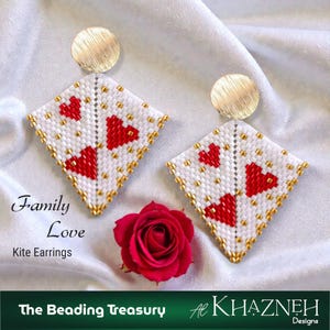 May include: White kite-shaped earrings with red heart designs and gold bead accents. The earrings have gold circular studs and are displayed on a white satin surface. The text "Family Love Kite Earrings" is visible.
