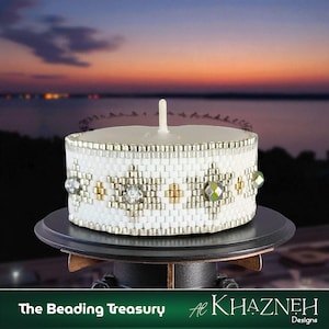 May include: A white beaded candle holder with a lit candle. The holder has a geometric pattern with gold and clear accents. The candle holder sits on a black stand, with a sunset in the background. Text at the bottom reads "The Beading Treasury" and "Al Khazneh Designs."