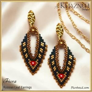 May include: A pair of Fiora Russian leaf earrings featuring dark navy and gold seed beads in a diamond shape with a central red bead. Each earring has a textured gold-tone metal top piece. The text reads AC KHAZNEH Designs and Fiora Russian Leaf Earrings.