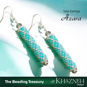 May include: A pair of tube earrings with a turquoise and silver beaded pattern. The earrings are labelled "Azara" and are from "The Beading Treasury" by Al Khazneh Designs. The earrings have silver hooks and end caps.
