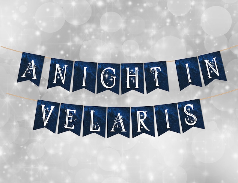 May include: A two-row banner featuring dark blue, galaxy-patterned pennants strung on twine. Each pennant displays a white letter with small star accents. The text reads A NIGHT IN VELARIS, with each letter printed on an individual swallowtail flag.