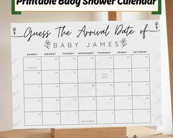 May include: A printable baby shower calendar with the text "Guess The Arrival Date of BABY JAMES." The calendar grid is white with floral accents and includes dates for August and September. It is displayed on a wooden stand.