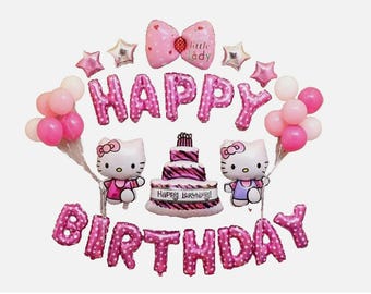 May include: A festive birthday balloon set featuring pink foil balloons spelling "HAPPY BIRTHDAY". The set includes Hello Kitty character balloons, star-shaped balloons, and a bow-shaped balloon with the text "little lady". A multi-tiered cake is also included.