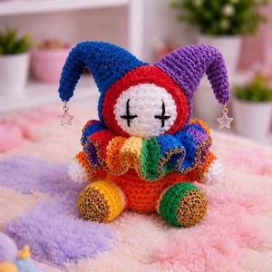 May include: A handmade crochet jester doll with a blue and purple hat, red and white face, and a rainbow collar. The doll has gold accents and star-shaped charms hanging from the hat. The doll is sitting on a colorful, plush rug.