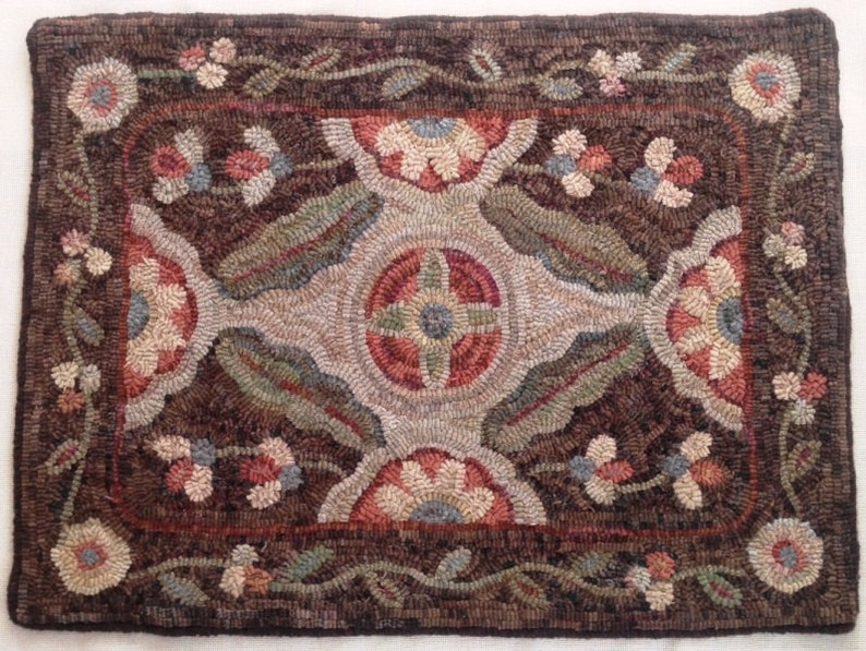 Puede incluir: Una alfombra rectangular, hecha a mano, con un fondo marr&oacute;n oscuro y un dise&ntilde;o floral central. La alfombra presenta un borde y un medall&oacute;n central con motivos florales y de hojas en tonos rojos, azules, verdes y beige. Las dimensiones de la alfombra no son visibles.