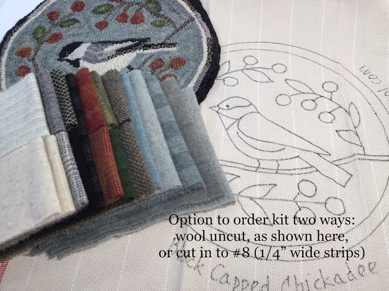 May include: A craft kit featuring a black-capped chickadee design. The image shows a completed rug, a canvas with the design outline, and various fabric swatches in shades of gray, blue, green, and red. Text indicates the kit can be ordered with uncut wool or pre-cut strips.