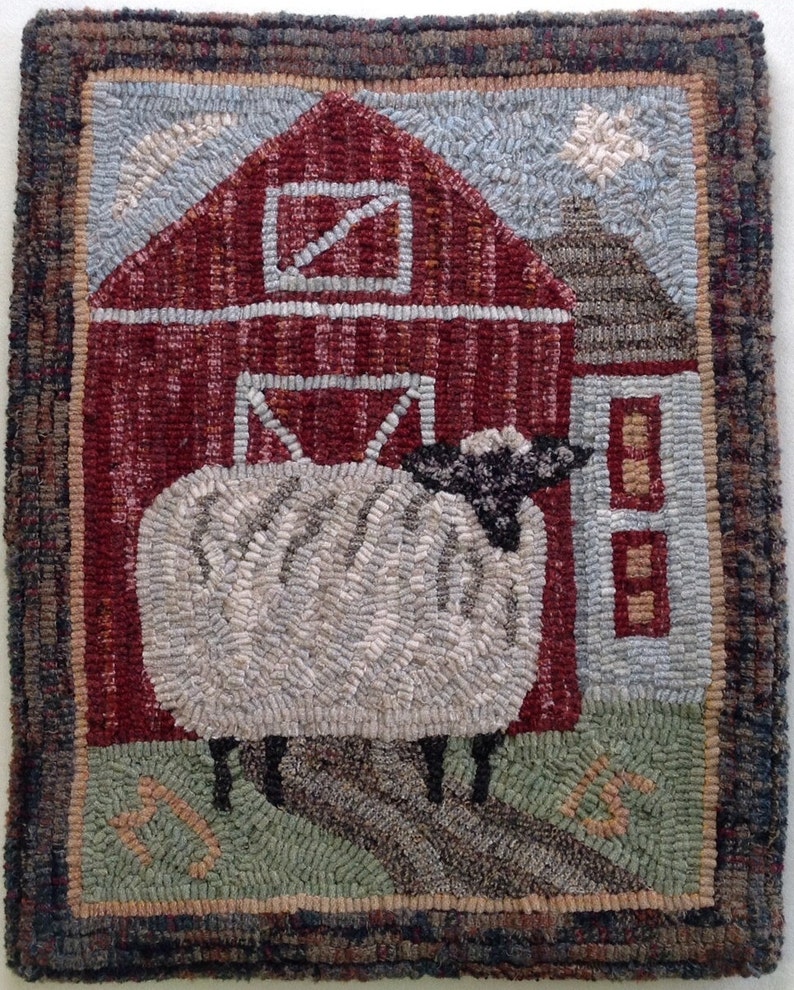May include: Hand-hooked wool rug featuring a rural scene. A red barn with a white door and a sheep are the focal points. The sheep is white with a black head, standing on a path. The rug has a brown border and a light blue sky.