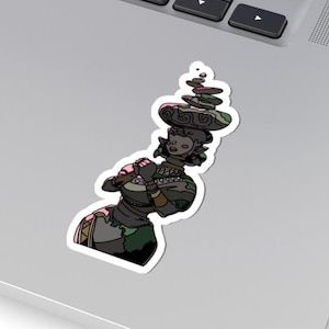 May include: A sticker featuring a stylized illustration of a person balancing a stack of stones on their head. The figure is depicted in shades of green, black, and pink, with a detailed design. The sticker is placed on a laptop.