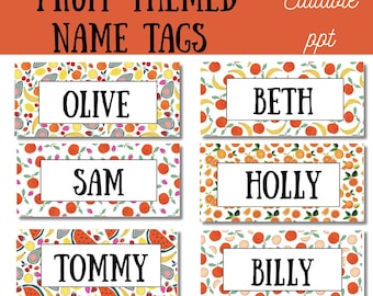 May include: Fruit-themed name tags with colorful fruit patterns. Each tag features a white rectangle with a name in bold black font. The tags are decorated with illustrations of oranges, bananas, strawberries, and other fruits. The top banner reads "Fruit Themed Name Tags".