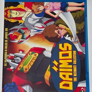 May include: Blu-ray disc of "Daimos: The Ultimate Collection" featuring colorful anime artwork. The cover displays a large robot, characters, and the title in a blue and yellow oval. Text indicates all 44 episodes are in English or Japanese.