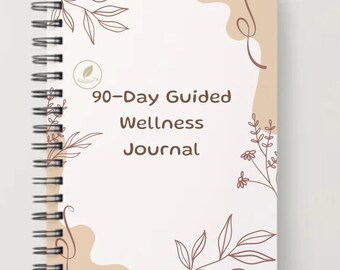 Può includere: Un diario a spirale con il testo "90-Day Guided Wellness Journal" sulla copertina. La copertina è color crema con disegni astratti e di foglie marroni. Il diario è su una superficie grigio chiaro.