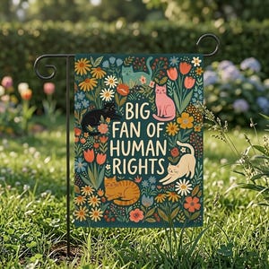 Może przedstawiać: Flaga ogrodowa z ciemnozielonym tłem przedstawia kolorowe kwiaty i koty w różnych pozach. Tekst "BIG FAN OF HUMAN RIGHTS" jest wyraźnie widoczny. Flaga jest trzymana przez czarny metalowy stojak, idealny do dekoracji na zewnątrz.