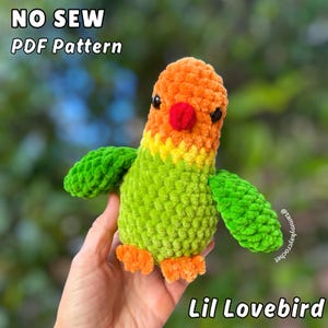 May include: A plush, handmade Lil Lovebird in shades of orange, green, and yellow. The bird has a red beak and black eyes. The text "NO SEW PDF Pattern" and "Lil Lovebird" are displayed on the image.